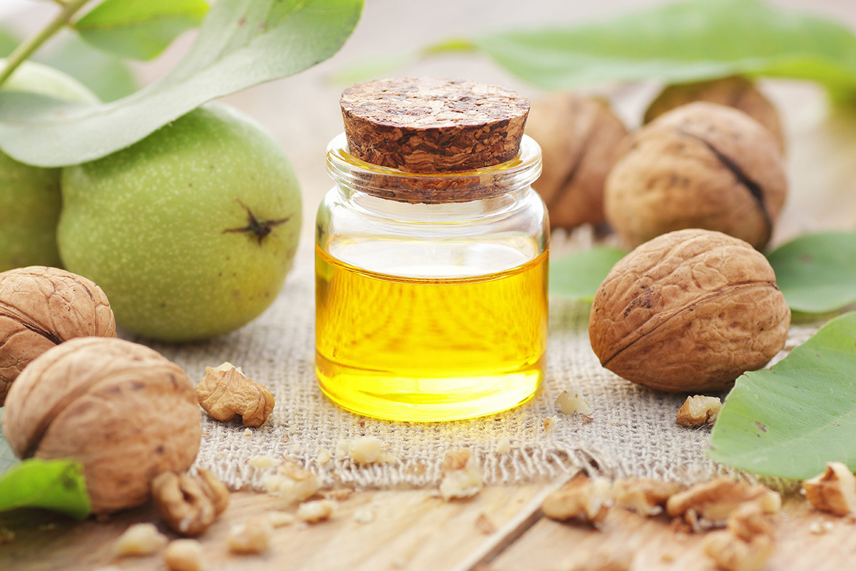 A glass bottle of natural oil used in aromatherapy massage treatments.